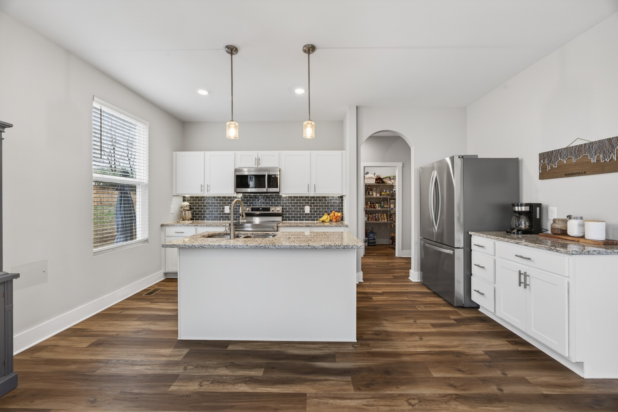 2030 Morgan Court Springfield, TN 37172 - Photo 11 of 29 a kitchen with stainless steel appliances granite countertop a refrigerator a stove and a sink with wooden floor