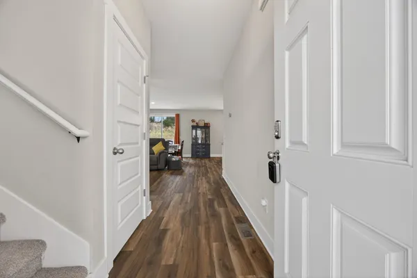 a view of a house with a door and a yard with wooden fence