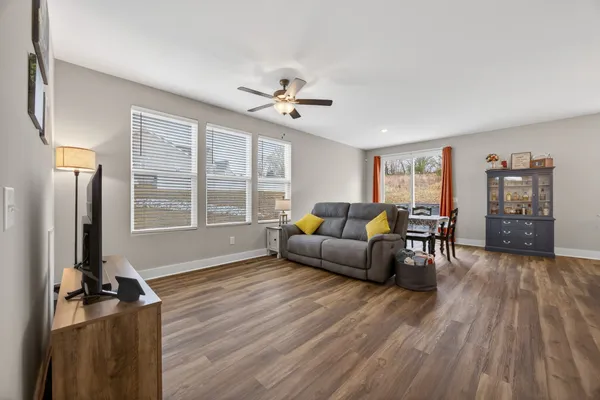 a living room with furniture and kitchen view