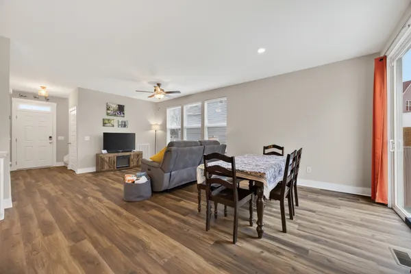 a view of a dining room with furniture and wooden floor