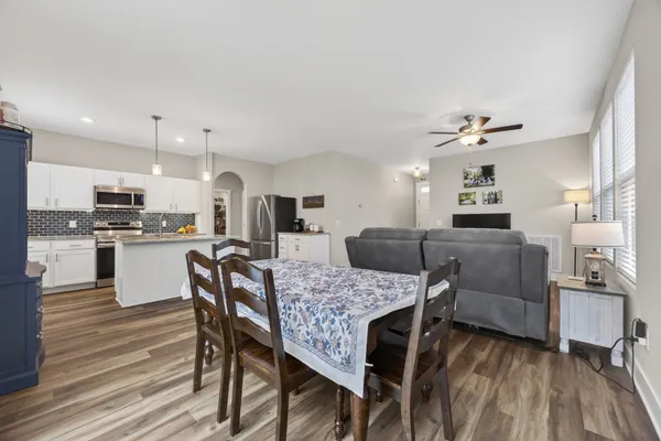 a kitchen with stainless steel appliances kitchen island granite countertop a stove a sink and a refrigerator