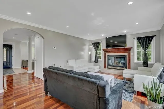 a living room with furniture fireplace and flat screen tv