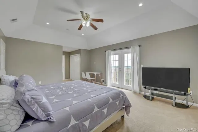 a bedroom with a bed and glass door