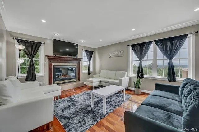 a living room with furniture flat screen tv and a fireplace