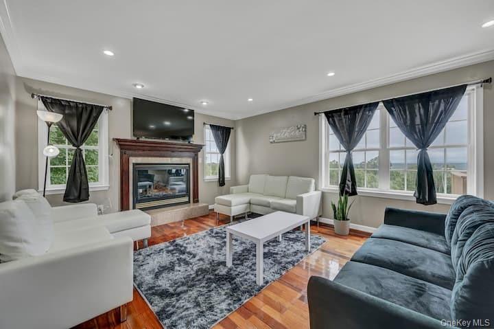 73 Mountain Road Bloomingburg, NY 12721 - Photo 7 of 19 a living room with furniture flat screen tv and a fireplace
