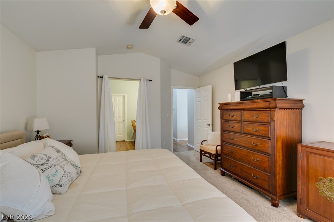 2187 Chapman Ranch Drive Henderson, NV 89012 - Photo 17 of 26 This serene bedroom offers a comfortable retreat with soft carpet flooring and a ceiling fan for optimal comfort.