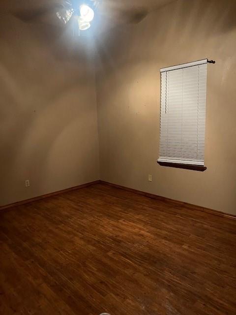 320 Northwest 9th Street Cooper, TX 75432 - Photo 4 of 13 an empty room with wooden floor and windows