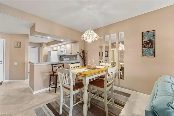 a view of a dining room with furniture and chandelier