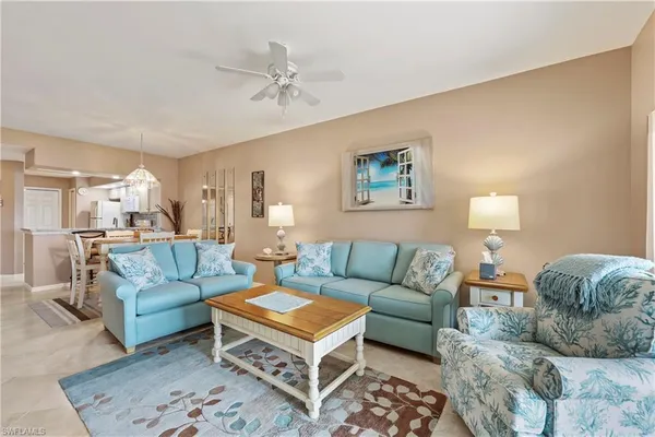 a living room with furniture and a lamp