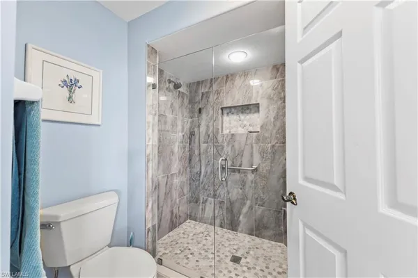 a bathroom with a shower toilet and sink