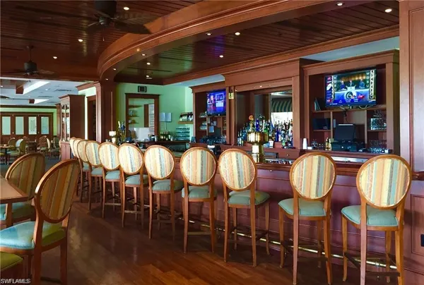 a view of a dining room with furniture wooden floor and chandelier