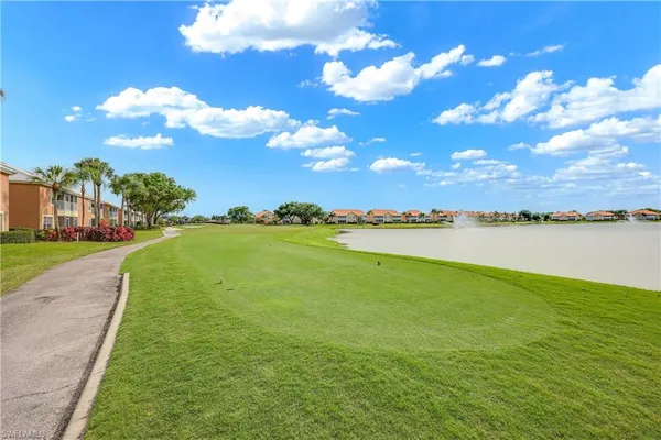 a view of a lake with houses in the background