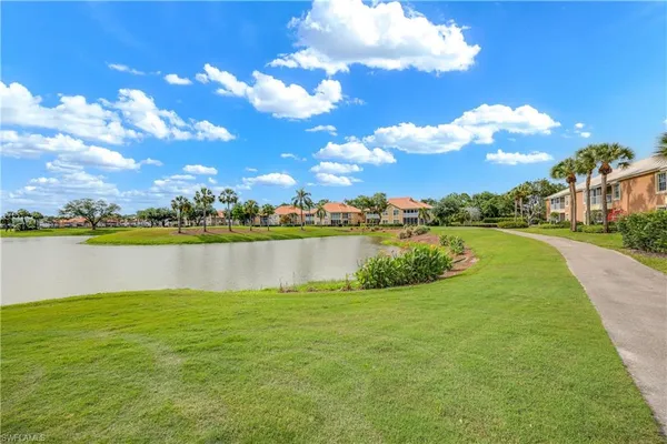 a view of a lake with houses in the background