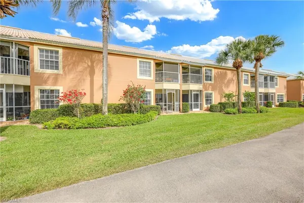 a view of a house with a big yard and potted plants