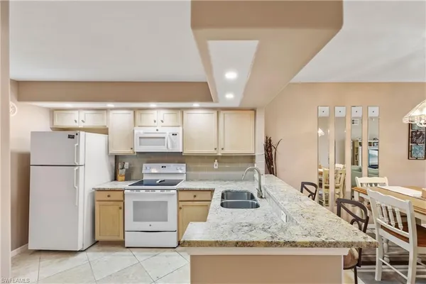 a kitchen with a stove a sink and a refrigerator