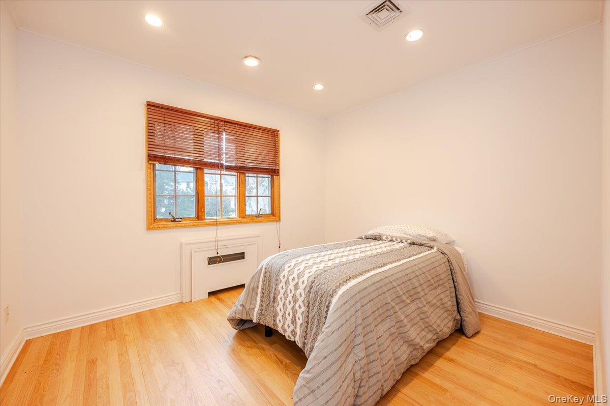 18 Locust Drive Great Neck, NY 11021 - Photo 15 of 29 a bedroom with a bed and a window