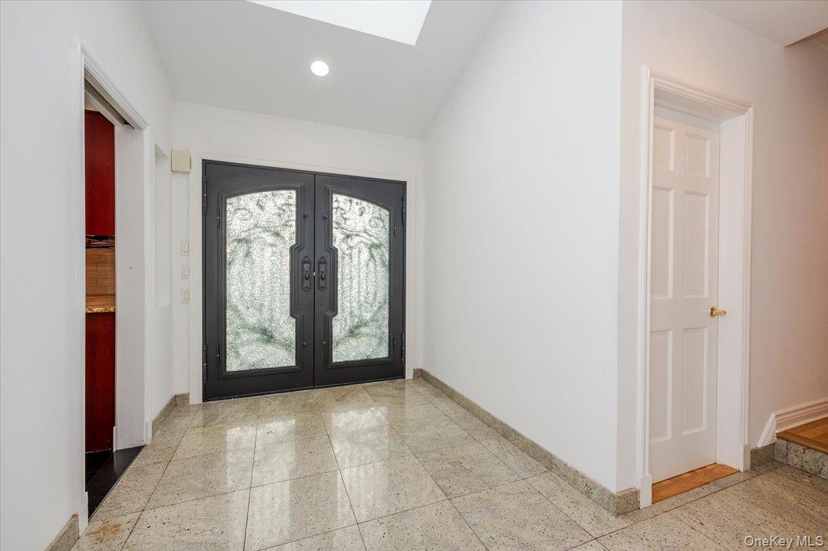 18 Locust Drive Great Neck, NY 11021 - Photo 2 of 29 a view of a room with an entryway and window