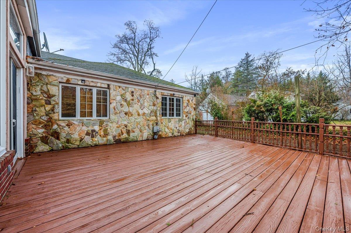 18 Locust Drive Great Neck, NY 11021 - Photo 25 of 29 a view of a house with a wooden deck