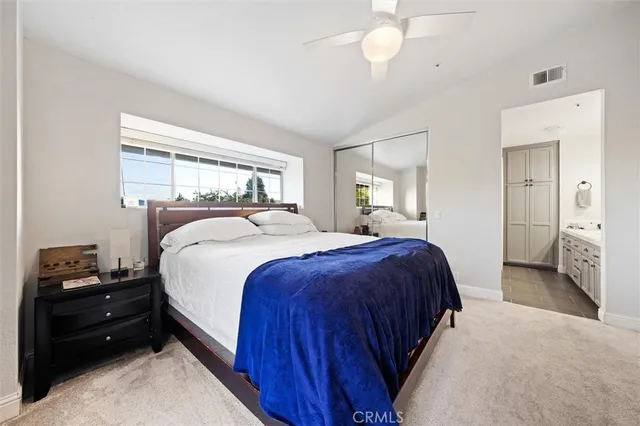 a bedroom with a bed and a mirror