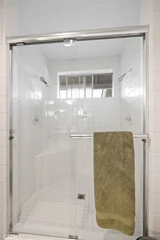 a bathroom with a glass shower door