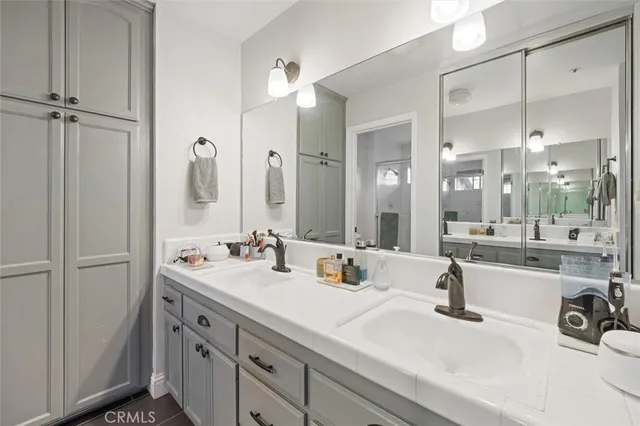 a bathroom with a sink double vanity and a mirror