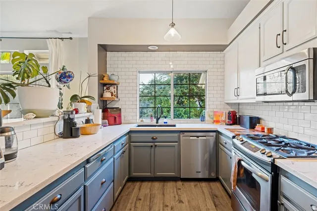 a kitchen with a sink stove and wooden cabinets