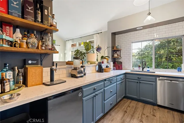 a kitchen with stainless steel appliances granite countertop a sink and wooden cabinets