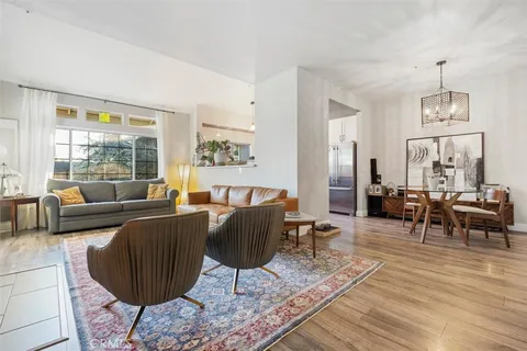 a living room with furniture large window and a table