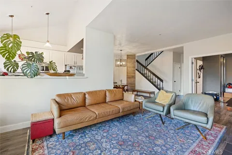 a living room with furniture a rug and a chandelier