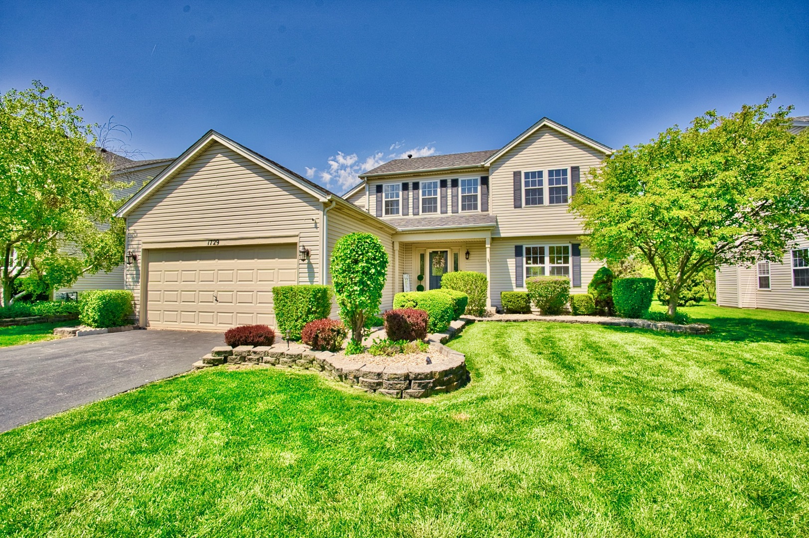 1729 Hidden Oaks Court Plainfield, IL 60586 - Photo 1 of 69 a front view of a house with a yard and porch