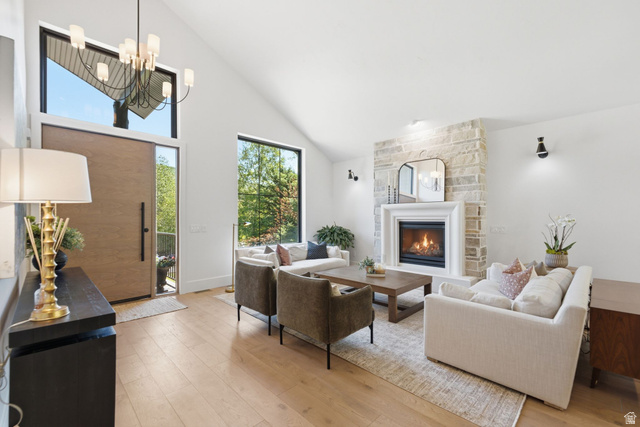 3027 Homestead Road Park City, UT 84098 - Photo 3 of 62 Vaulted ceiling living space featuring a stone fireplace with a white mantel, hardwood flooring, and a large front door with sidelight and transom windows