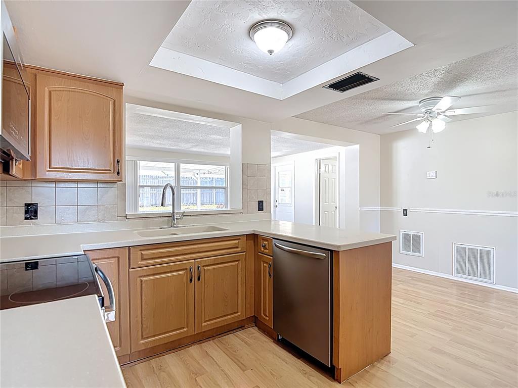 10806 Jason Road Port Richey, FL 34668 - Photo 13 of 46 a kitchen with stainless steel appliances granite countertop a sink and cabinets