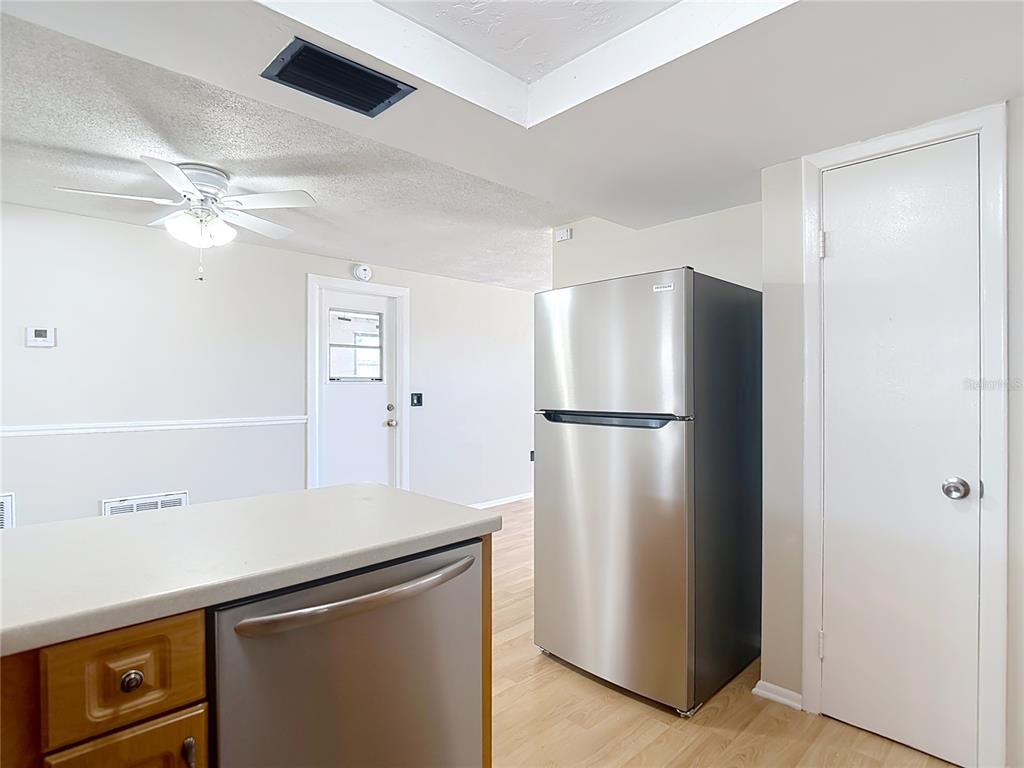 10806 Jason Road Port Richey, FL 34668 - Photo 16 of 46 a kitchen with stainless steel appliances a refrigerator and cabinets