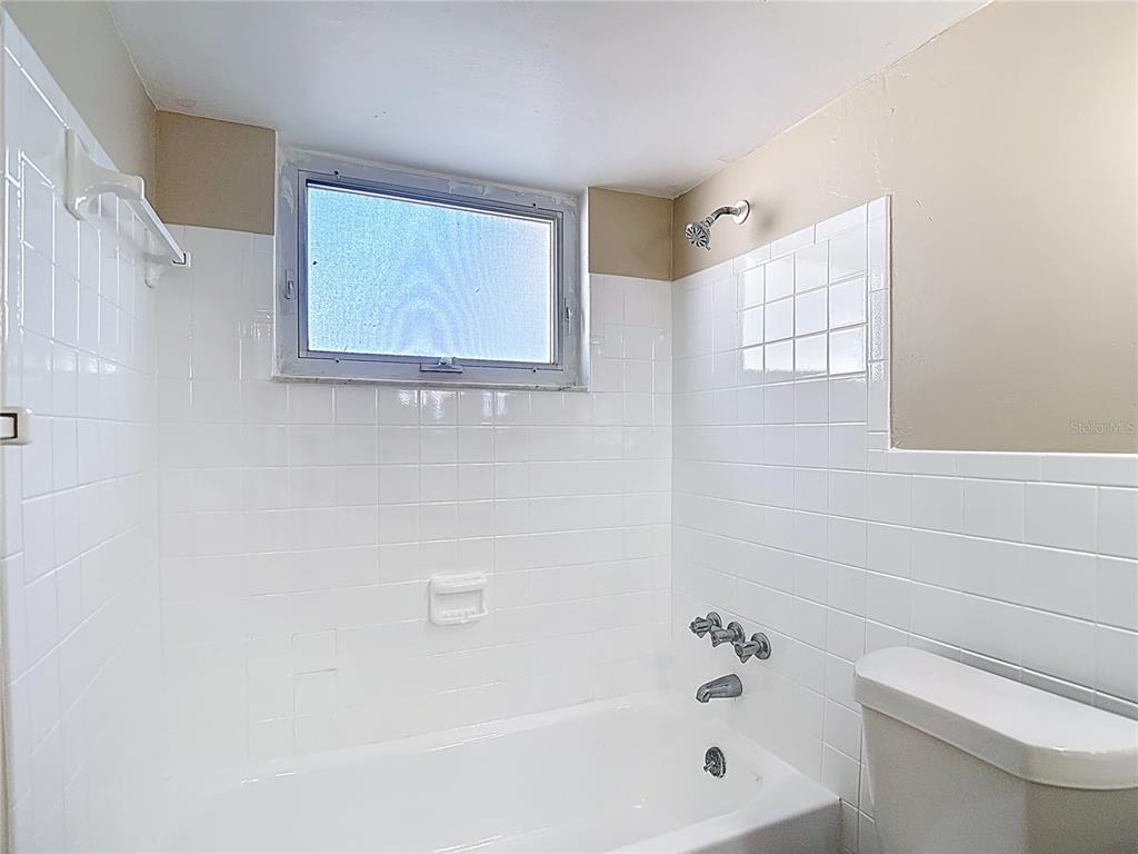 10806 Jason Road Port Richey, FL 34668 - Photo 26 of 46 a white bath tub sitting next to a white toilet