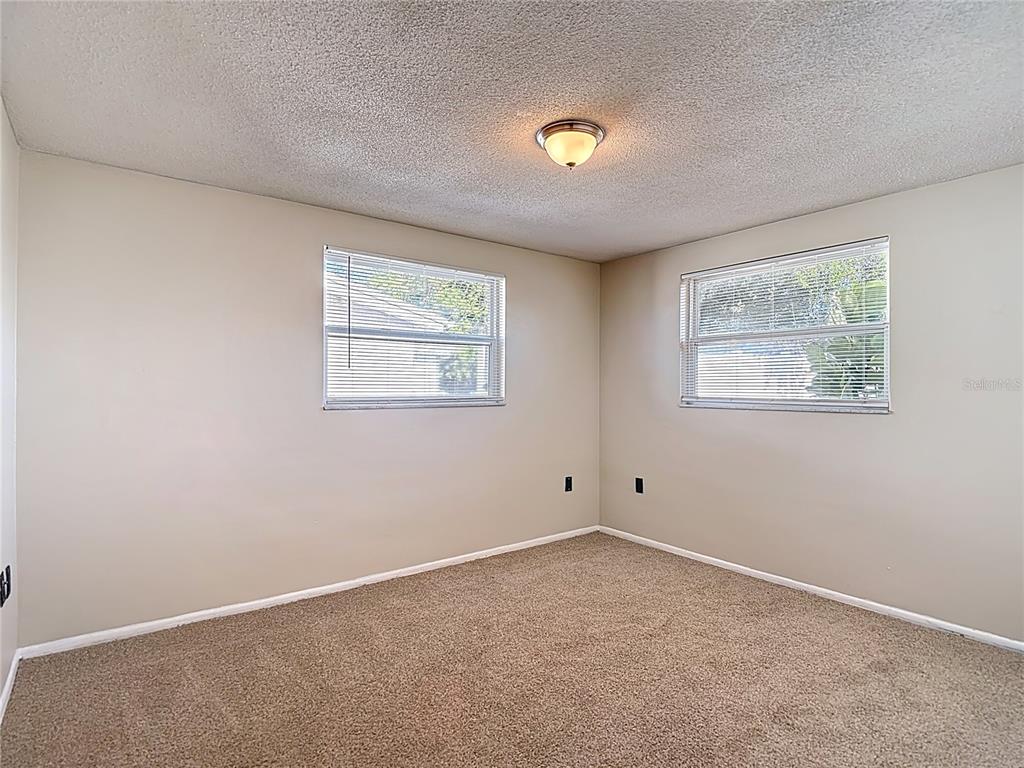 10806 Jason Road Port Richey, FL 34668 - Photo 27 of 46 an empty room with windows