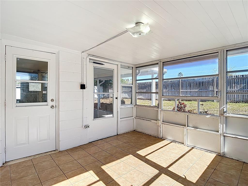 10806 Jason Road Port Richey, FL 34668 - Photo 36 of 46 a room with window and chandelier