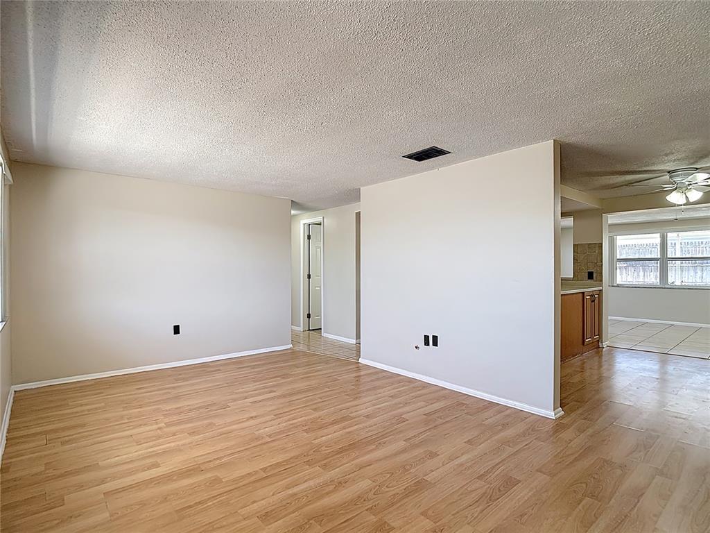 10806 Jason Road Port Richey, FL 34668 - Photo 6 of 46 a view of empty room with wooden floor