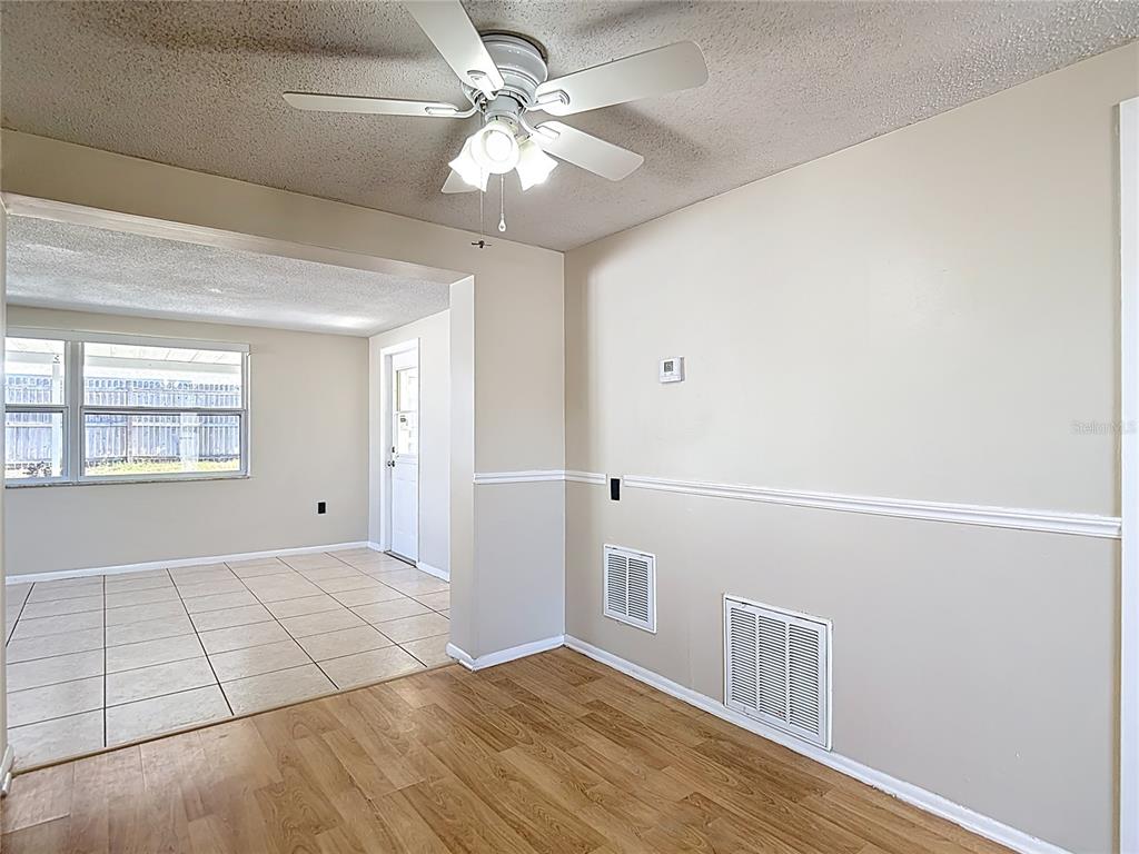 10806 Jason Road Port Richey, FL 34668 - Photo 10 of 46 wooden floor in an empty room with a window