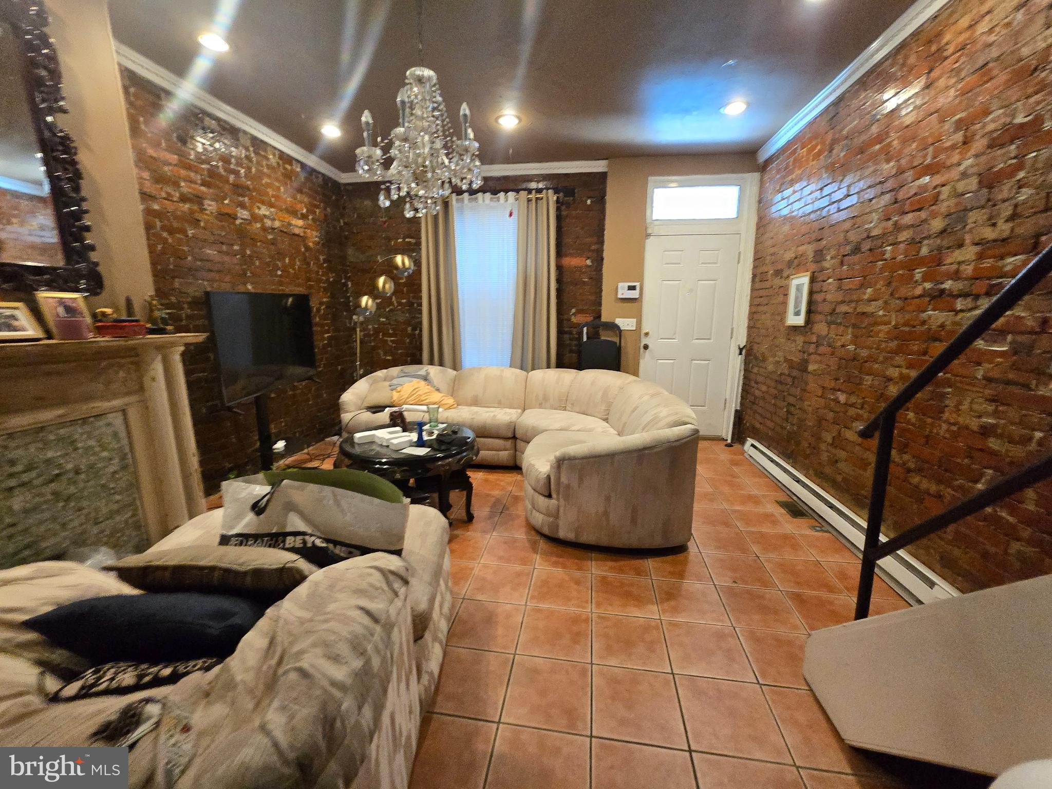 1211 North 60th Street Philadelphia, PA 19151 - Photo 2 of 14 a living room with furniture and a chandelier
