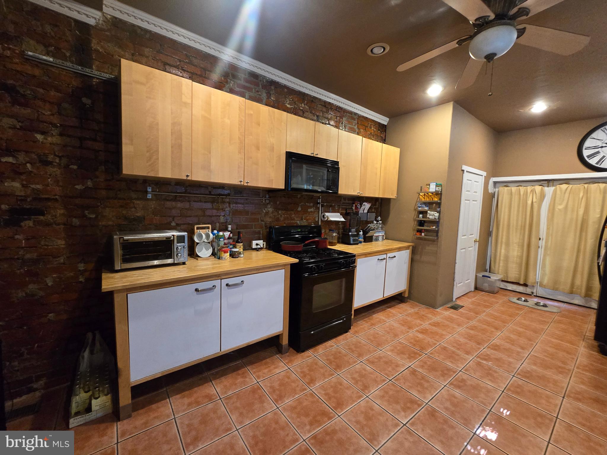 1211 North 60th Street Philadelphia, PA 19151 - Photo 8 of 14 a kitchen with stainless steel appliances granite countertop a sink and a stove
