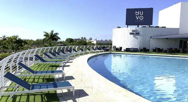 a view of a swimming pool with outdoor seating and plants