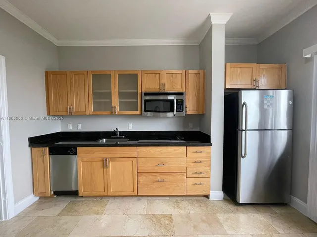 a kitchen with stainless steel appliances granite countertop a refrigerator and a sink