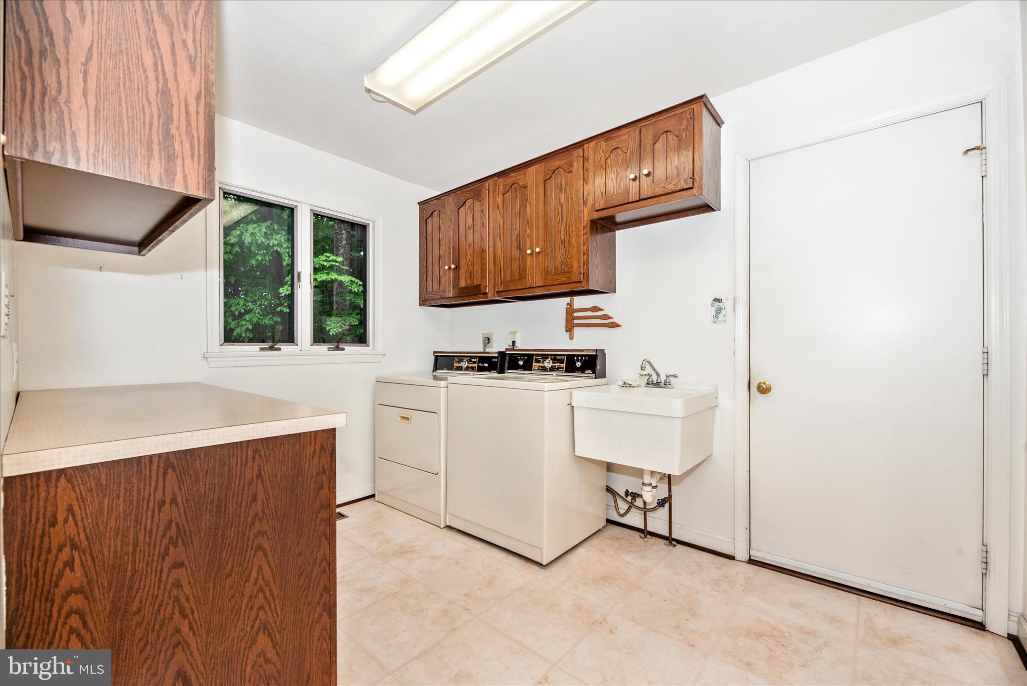 2221 Gold Mine Road Brookeville, MD 20833 - Photo 26 of 60 a utility room with cabinets washer and dryer