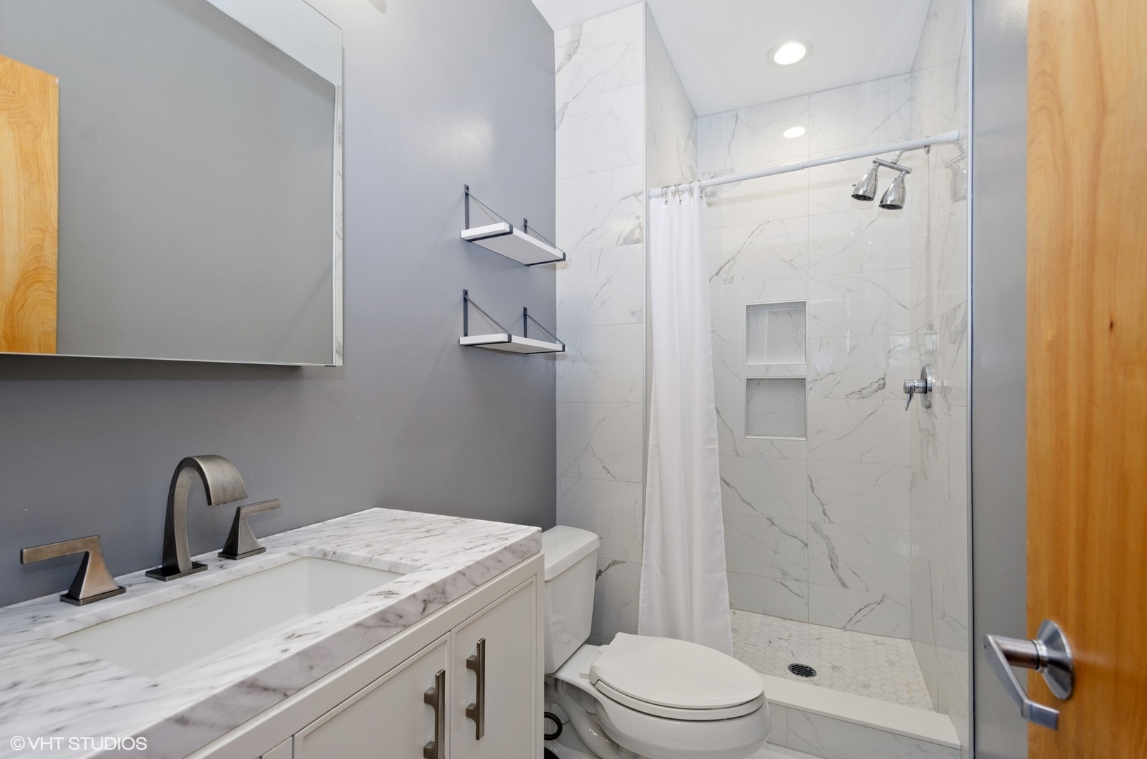 1442 North Mohawk Street, Unit 1 Chicago, IL 60610 - Photo 13 of 15 a bathroom with a granite countertop sink a toilet and shower