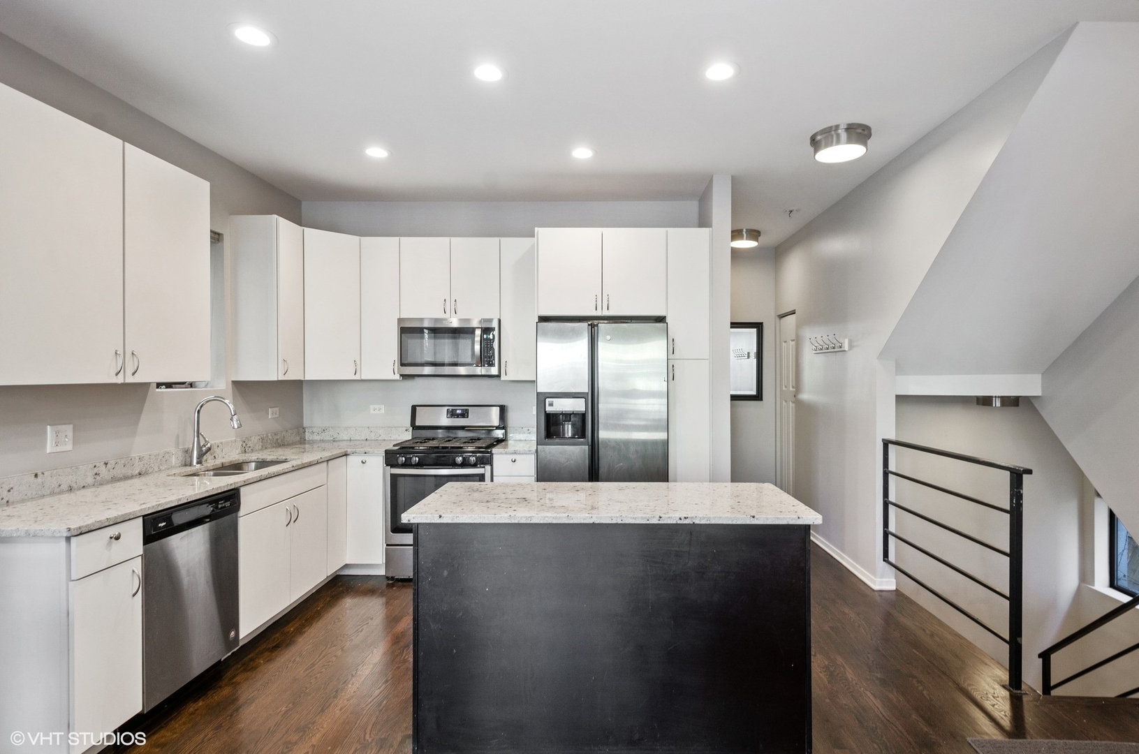 1442 North Mohawk Street, Unit 1 Chicago, IL 60610 - Photo 7 of 15 a kitchen with stainless steel appliances granite countertop a refrigerator a sink dishwasher a stove and white cabinets with wooden floor