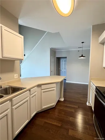 a kitchen with a stove a sink and a refrigerator