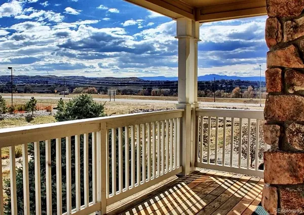 a view of a balcony with wooden floor