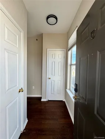 a view of a room with wooden floor and windows