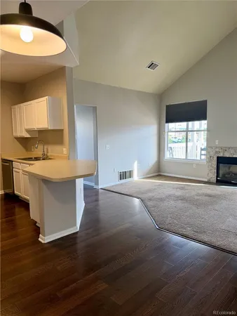 a view of empty room with a fireplace