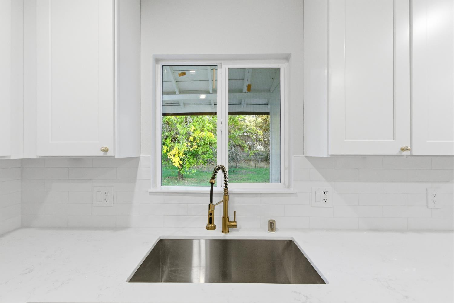 4117 El Dorado Road Placerville, CA 95667 - Photo 11 of 54 a kitchen with a sink a large window and cabinets